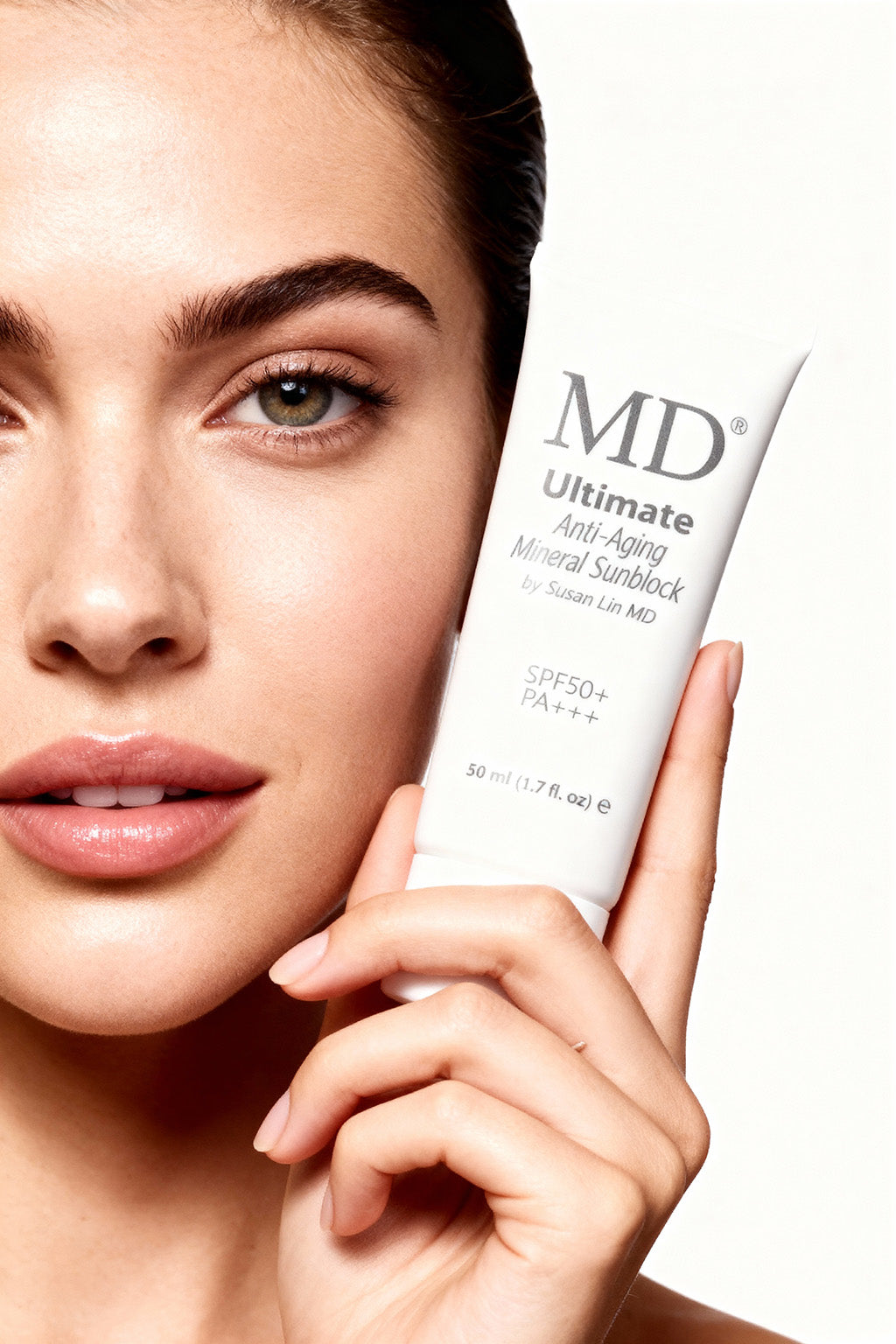 MD mineral sunblock held by woman showing the invisible, pore-blurring finish and anti-aging antioxidant protection